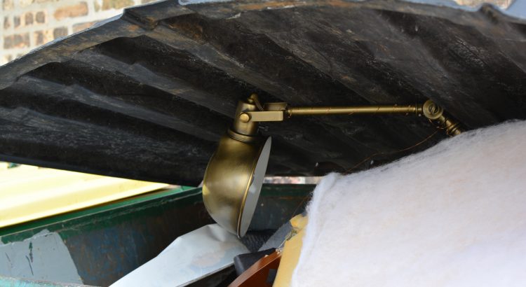 Golden desk lamp in green dumpster