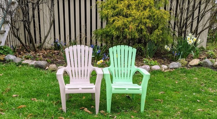 Two empty lawn chairs sitting side by side