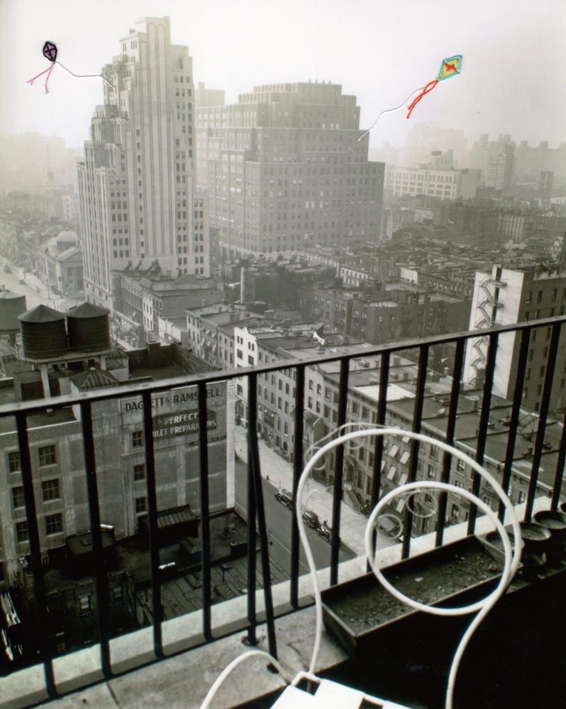Embroidered thread kites by Jackie Mantey peek out of black and white buildings, photographed by Berenice Abbott.